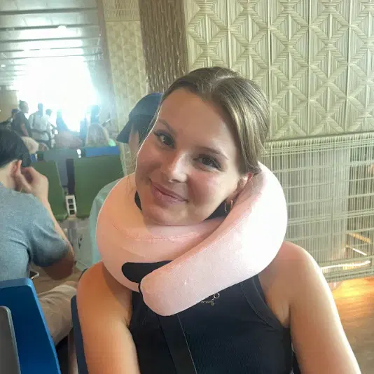 Ella R. using the FlyHugz® travel pillow
