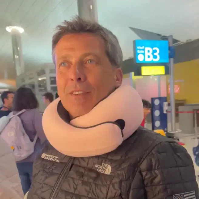 George H. using the FlyHugz® travel pillow